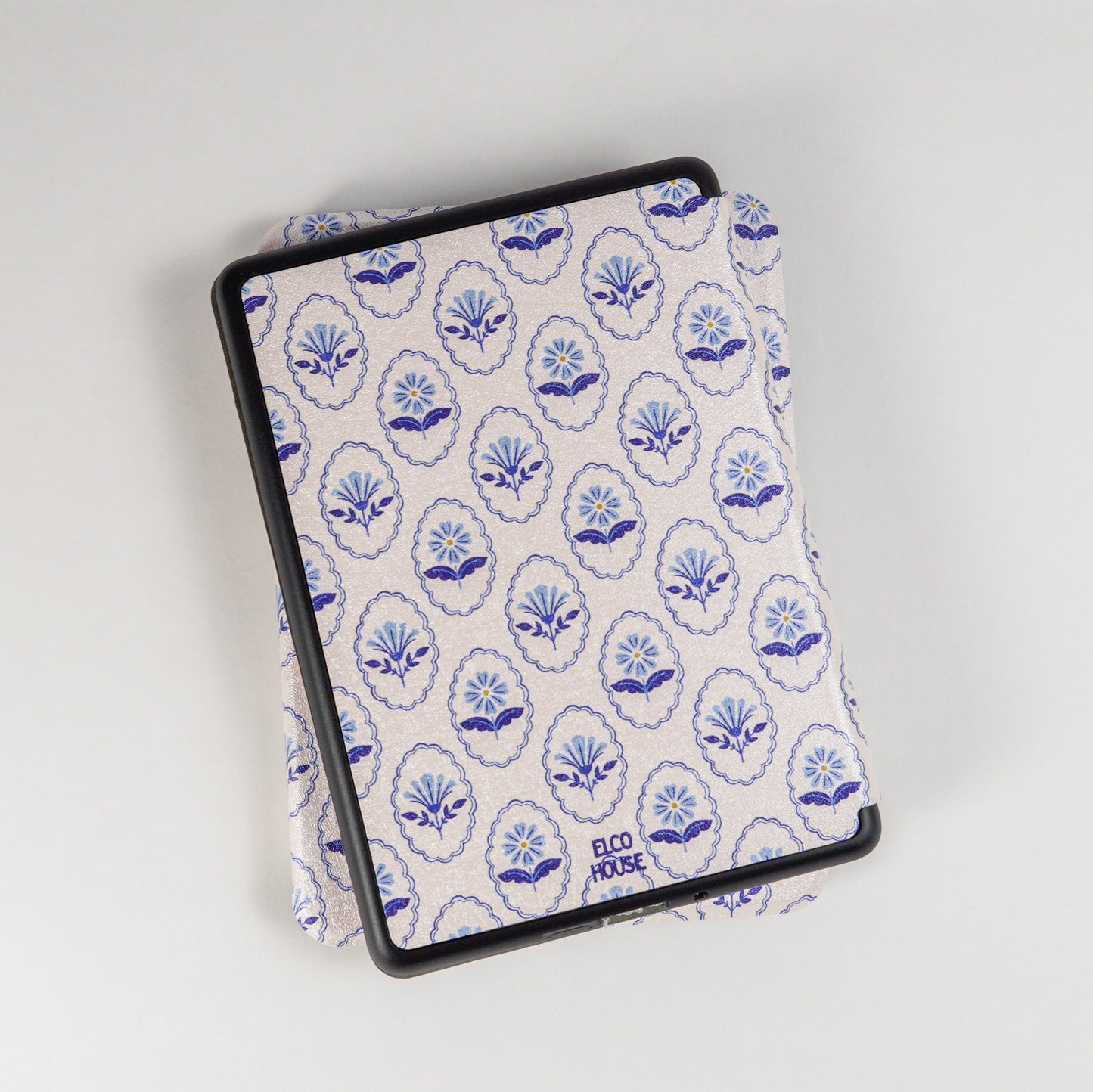 Back of Bloom Service Kindle Case showing repeating floral pattern with framed flowers and elco house logo