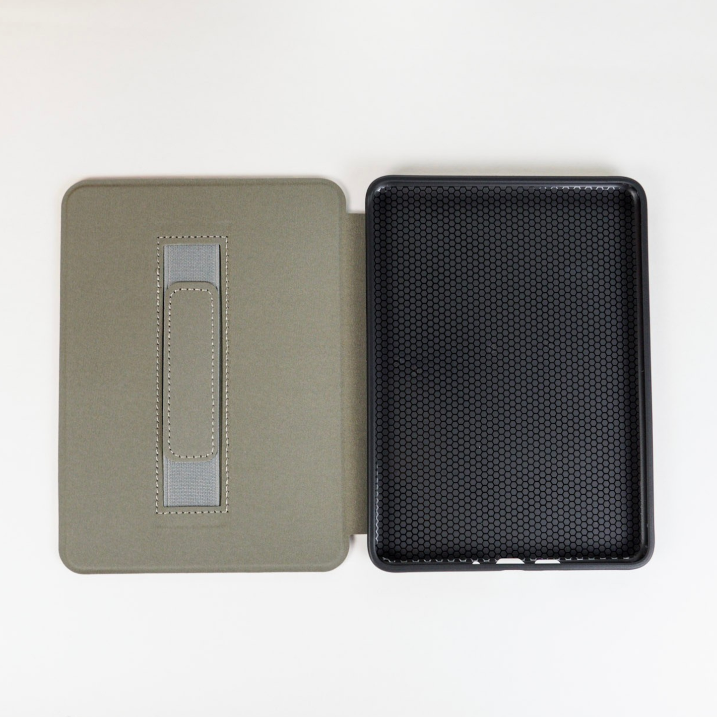 open kindle case with grey strap on left side and black rubber on right side
