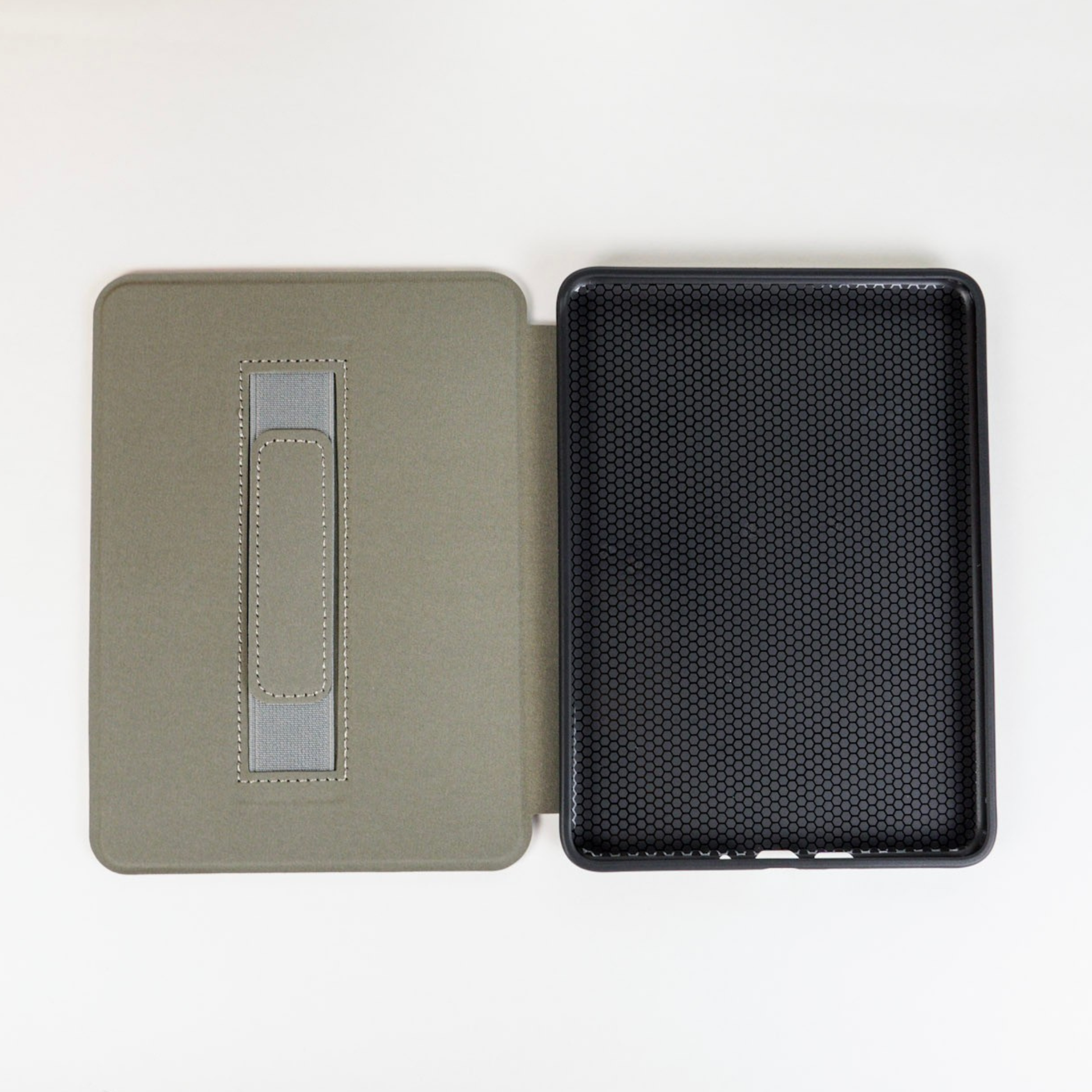 open kindle case with grey strap on left side and black rubber on right side 